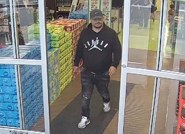 A suspect in a theft and fraud investigation exiting the store. 