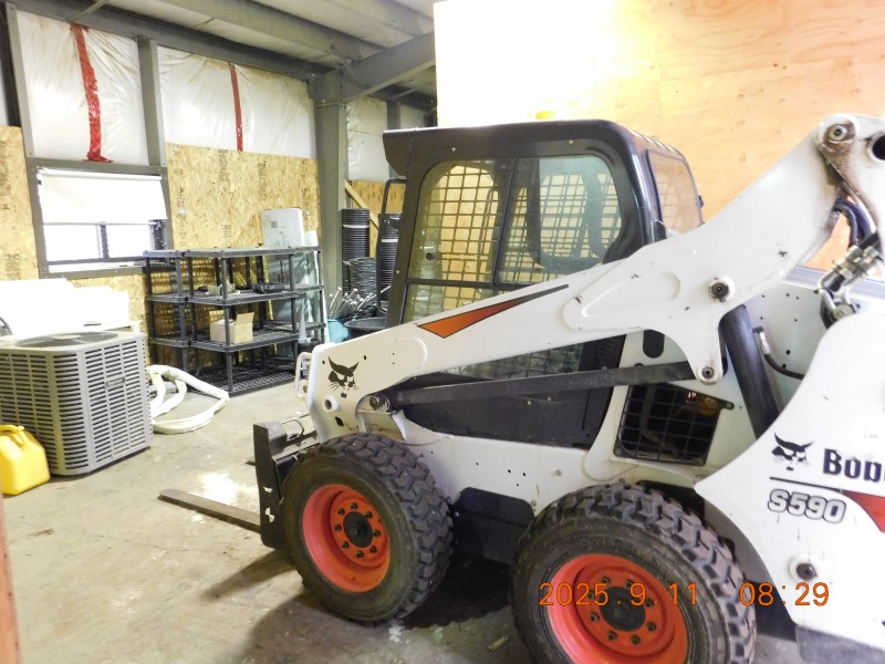 Bobcat skid-steer loader located and seized during the execution of the search warrant. 