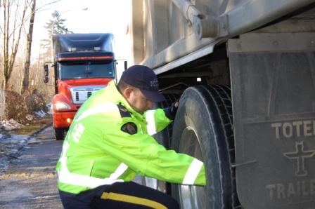 Officer assessing a truck’s tire